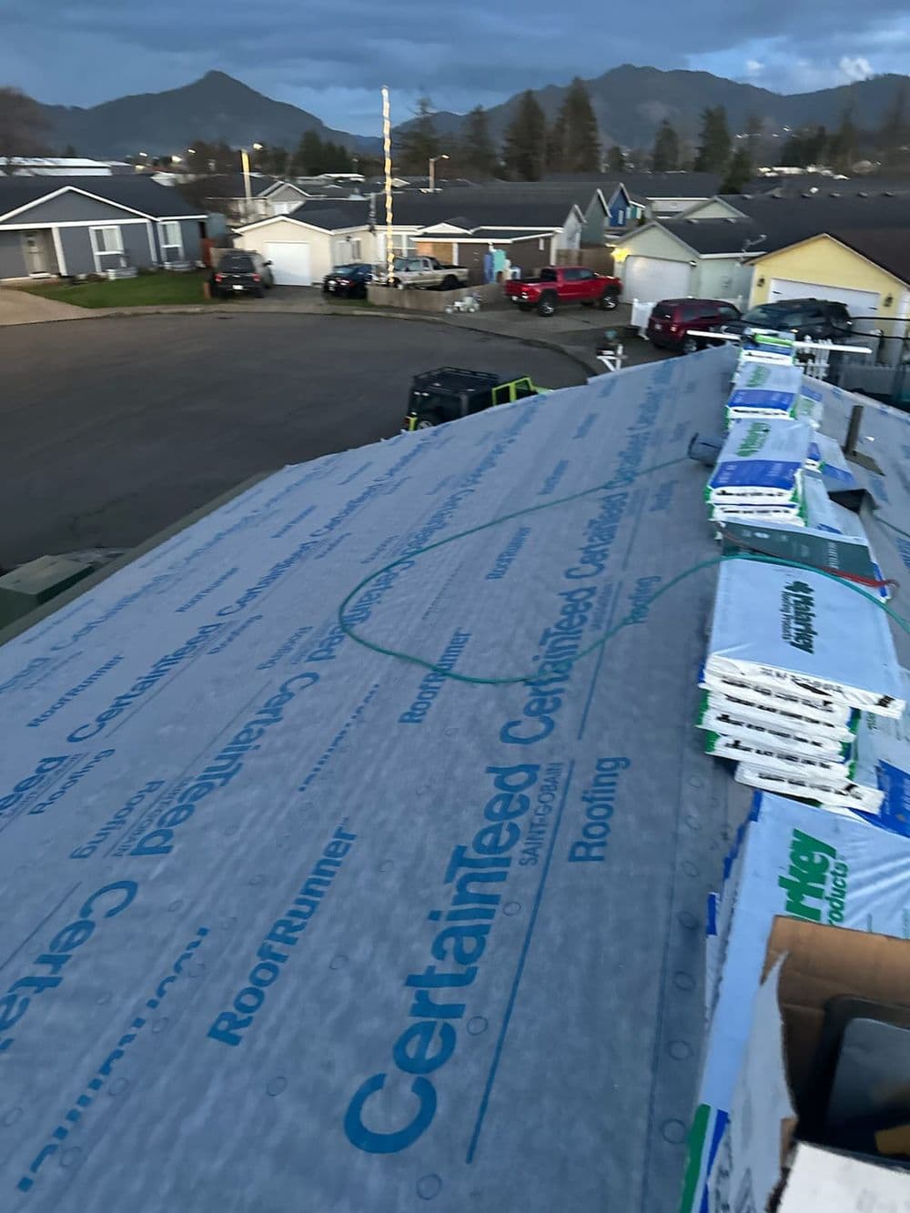 Roofing materials by CertainTeed on a residential home with mountains in the background.