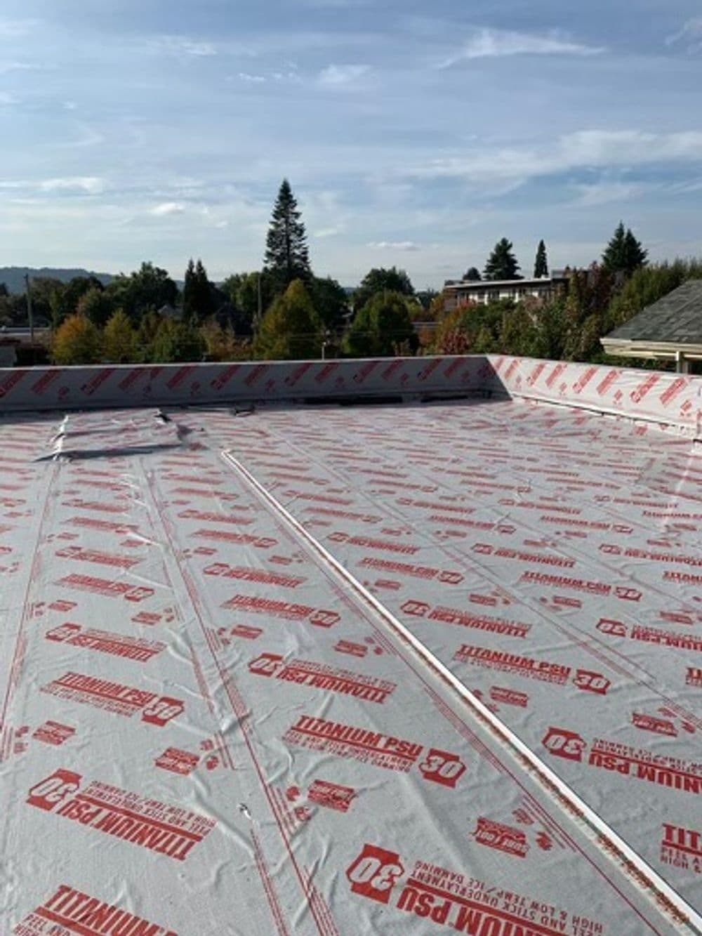 Flat roof installation featuring Titanium PSU underlayment in a residential setting.